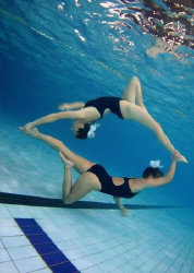 Connected. Synchro swimmers in a pool. by Alena Vorackova 